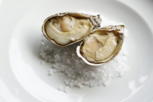 Plump oysters on plate